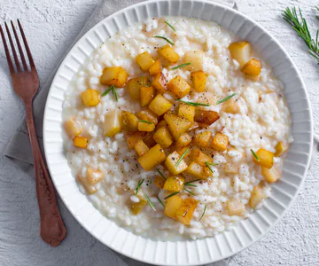 Risotto with stracchino cheese, pears and hazelnut