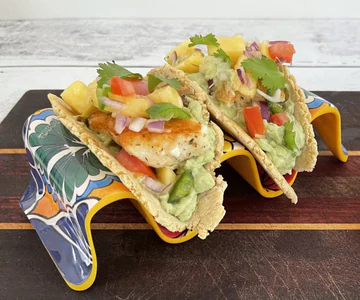 Fish tacos with pineapple salsa and avocado crema