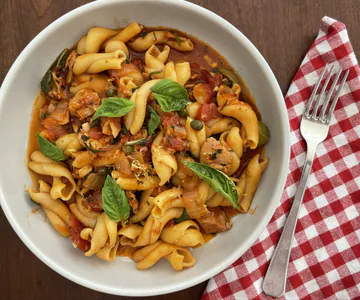 Pasta with canned tuna, olives, capers and tomatoes