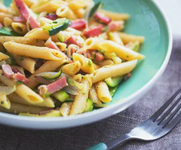 Penne with speck and zucchini