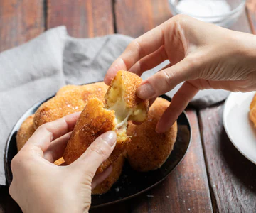 Potato croquettes with a cheesy mozzarella and ham center