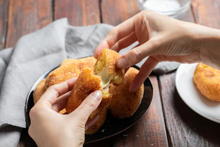 Potato croquettes with a cheesy mozzarella and ham center