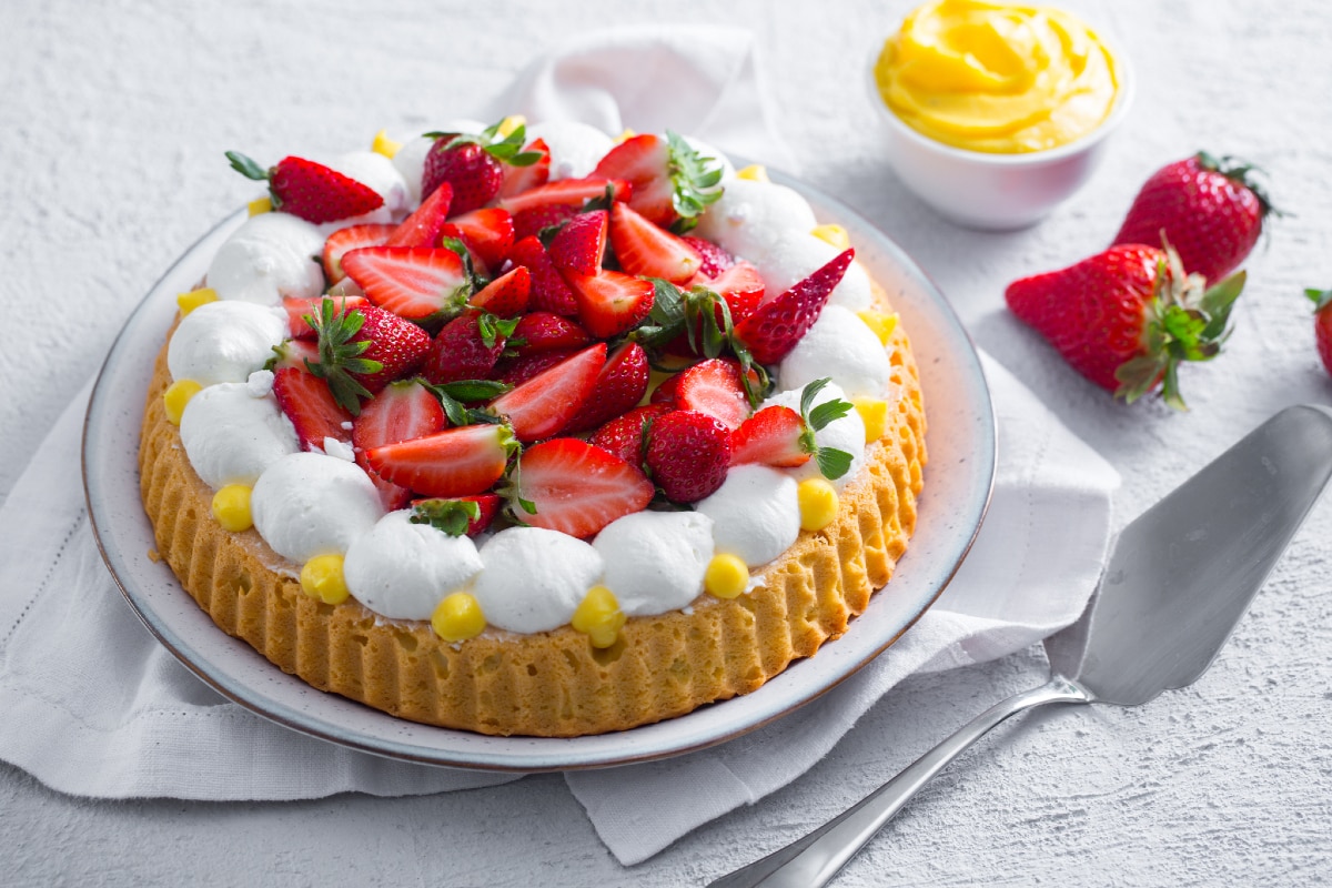 Soft tart with cream, whipped cream, and strawberries