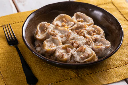 Ricotta and herb ravioli with walnut sauce