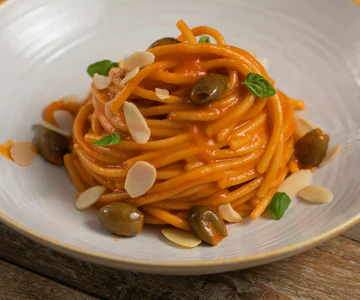 Pasta with roasted pepper cream, olives and almonds