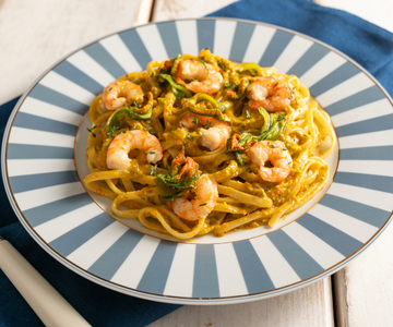 Linguine with zucchini flower pesto, prawns and zucchini blossoms