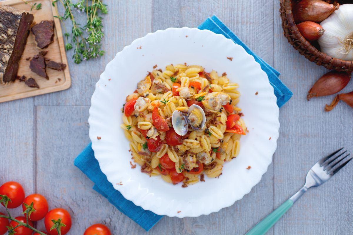 Malloreddus with clams, cherry tomatoes, and tuna bottarga