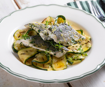 Steamed sea bass with lemon and marinated zucchini