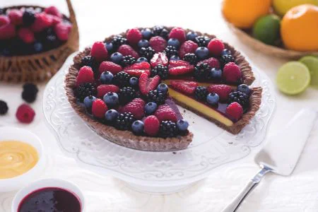 Cocoa tart with citrus curd and berry coulis