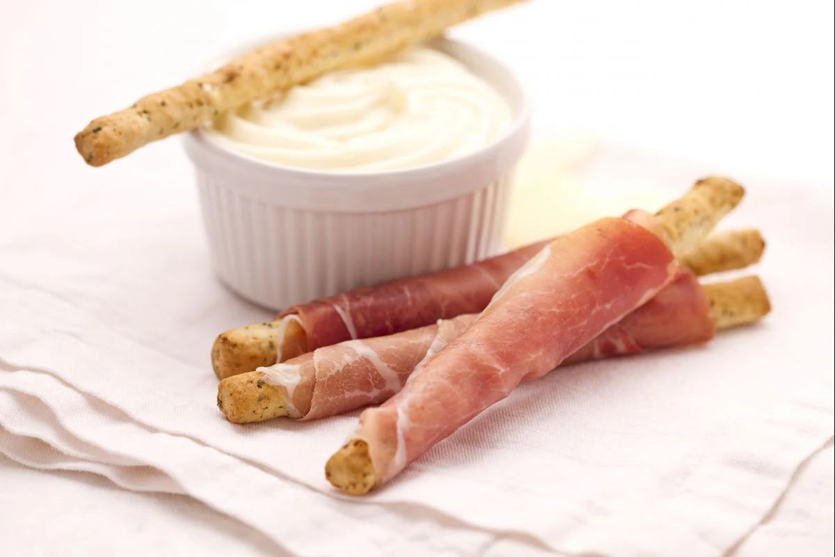 Olive breadsticks with prosciutto and Montasio