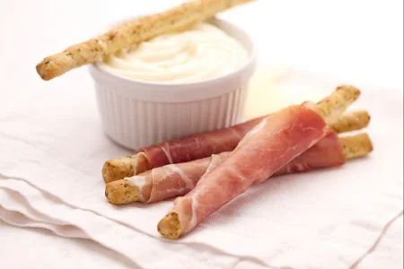Olive breadsticks with prosciutto and Montasio