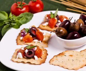 Olive puffs with tomato and feta crumbs