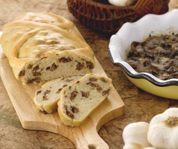 Bread strudel stuffed with sausage and flavorful mushroom pan