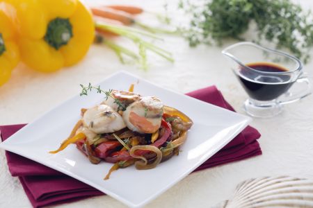 Scallops on a bed of caramelized onions with soy carrots and peppers