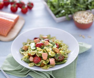 Farfalle with salmon, snow peas, and confit cherry tomatoes with arugula pesto