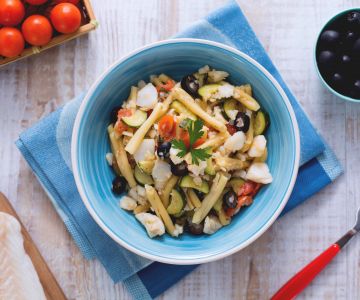 Casarecce with cod sauce, zucchini, and black olives