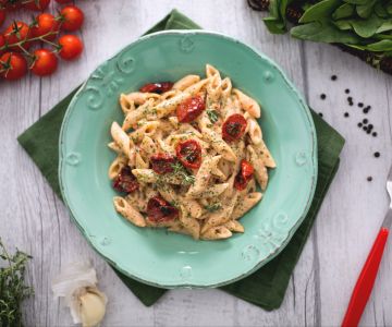 Whole wheat mezze penne rigate with roasted tomato pesto, ricotta, and spinach powder