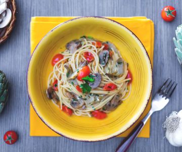 Spaghetti with mushrooms, artichokes, and cherry tomatoes
