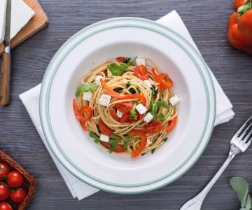 Whole wheat spaghetti with red peppers, arugula, and feta