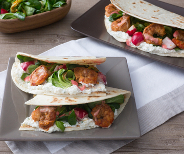 Flatbread with shrimp, zucchini flowers, and salad