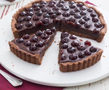 Hazelnut tart with dark chocolate ganache and sour cherries