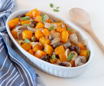 Pumpkin in the pan with onions and olives