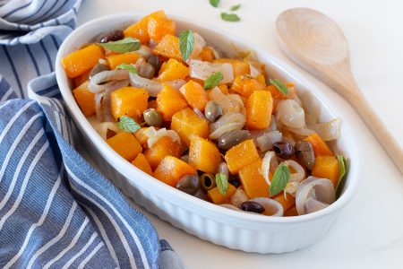 Pumpkin in the pan with onions and olives