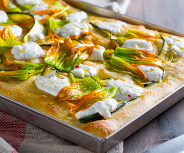 Potato focaccia with burrata and zucchini flowers