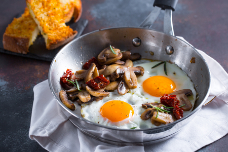 Fried eggs with mushrooms and sun-dried tomatoes