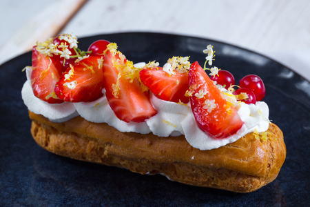 Cream-filled Éclair with whipped cream