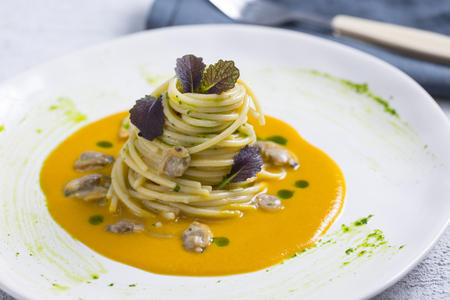 Spaghetti with clams, pumpkin sauce, and mandarin mustard