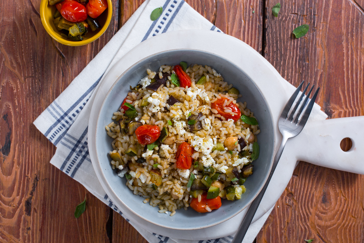 Warm rice with chickpeas, roasted vegetables, and feta