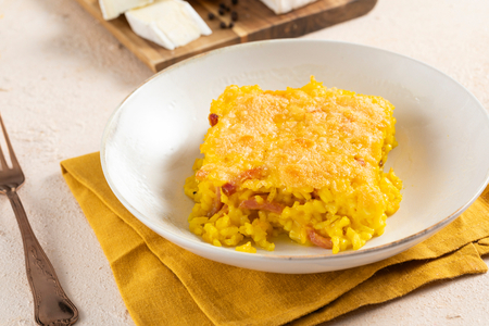 Baked saffron rice with speck and brie