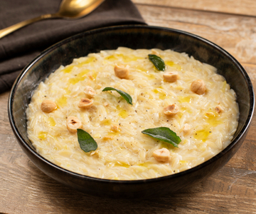 Orzo with leeks, robiola cheese, and hazelnuts