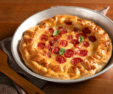 Savory pie with cherry tomatoes and scamorza cheese