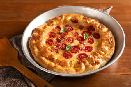 Savory pie with cherry tomatoes and scamorza cheese