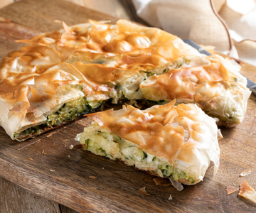 Savory pie with phyllo dough in a pan with zucchini