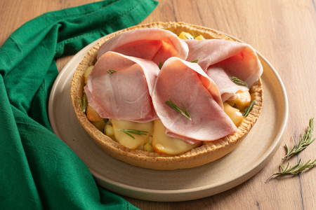 Savory tart with ham, smoked cheese, and potatoes