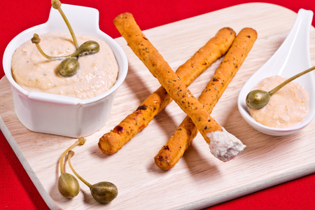 Breadsticks with tuna cream and caper flowers