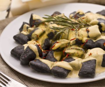 Squid ink gnocchetti with sea bass and saffron sauce