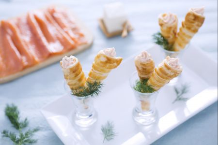 Mini puff pastry croissants with salmon and cream cheese filling