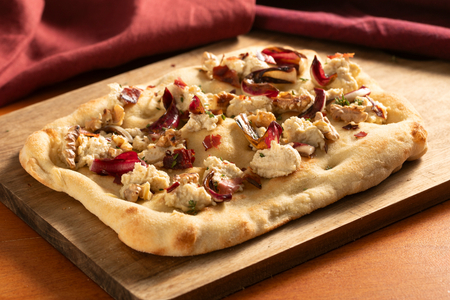 Pinsa with radicchio, speck and walnuts