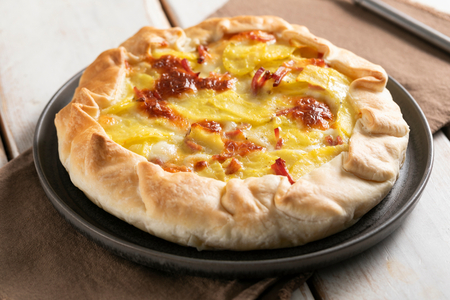 Savory tart with speck and potatoes