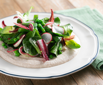 Spring vegetables on cannellini bean puree