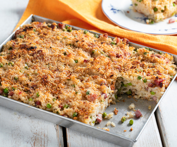 Cheesy Baked Rice with Peas and Speck