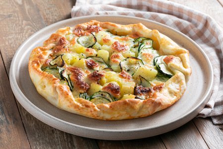 Savory tart with potatoes, zucchini and mozzarella